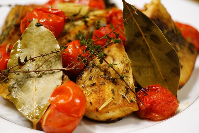 Swordfish with roasted tomatoes and bay leaves on a plate